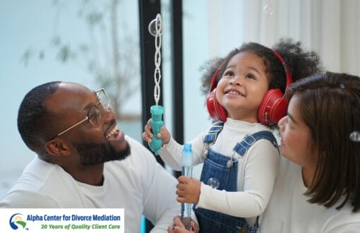 A couple enjoying quality time with their daughter, all dressed in white and smiling happily.