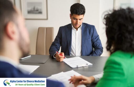 A couple sitting across from each other in front of a mediator, discussing divorce.